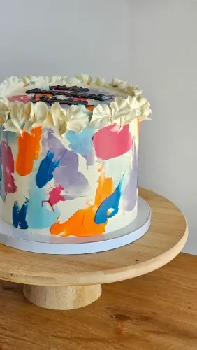 Buttercream cake with colourful abstract brushstroke design
