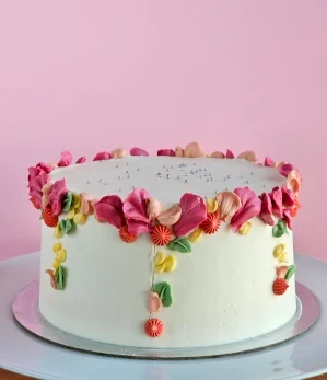 White cake with colourful buttercream petals