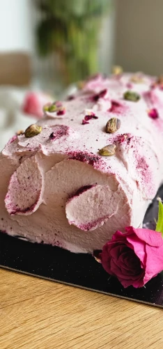 Pink pistachio roll cake with rose petals