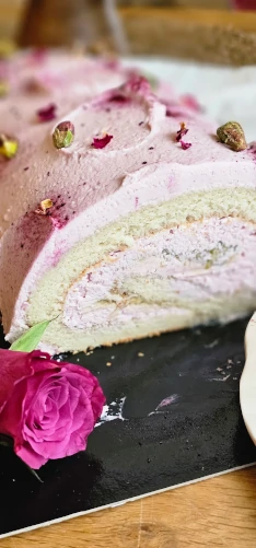 Pink roll cake slice with cream filling