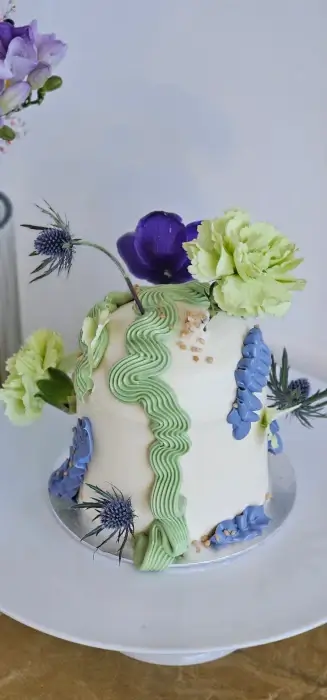 Dome buttercream cake with blue flowers